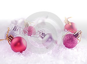 Christmas decoration balls in the deep snow. Image has a vintage effect applied. Greeting card template. Winter holiday