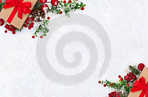 Christmas decoration, banner. Gift box with red ribbon, bow, twigs christmas tree, red berries and apples on snow