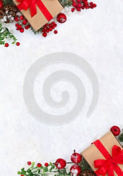 Christmas decoration, banner. Gift box with red ribbon, bow, twigs christmas tree, red berries and apples on snow