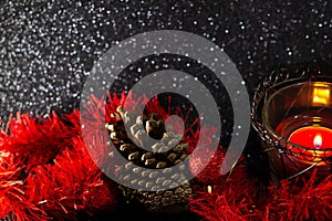 Christmas decoration on black surface with sparkles.
