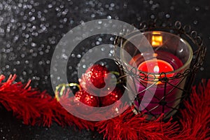 Christmas decoration on black surface with sparkles.