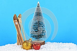 Christmas decoration on blue background. Christmas tree and skis on blue background