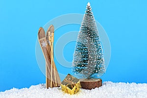 Christmas decoration on blue background. Christmas tree and skis on blue background