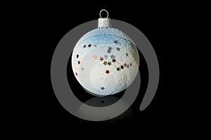 Christmas decoration blue and white ball with multicolored sequins stars. Isolated on black background.