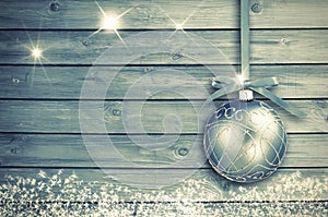 Christmas decoration on a blue wooden board with white snow, snowflakes, ice crystals. Simple Christmas, New Year card.