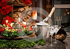 Christmas decoration. bottle of champagne, glasses and fireplace