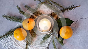 Christmas decoration with candle and calendar, white knitted scarf on wooden background