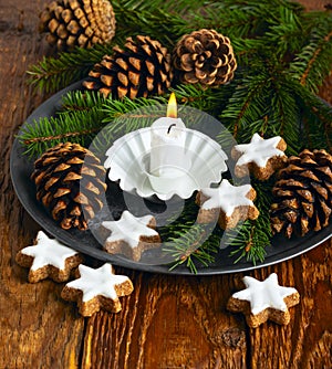 Christmas decoration with candle, cones and cookies