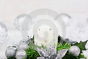 Christmas decoration with candle, fir branch and silver balls on white background