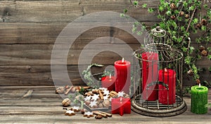 Christmas decoration with candles, cookies and pine branch