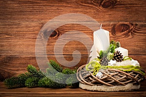 Christmas decoration - christmas composition with wreath and candles on the wooden background.