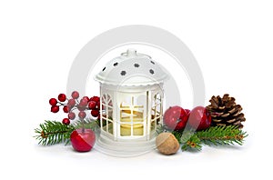 Christmas decoration. Christmas lantern, red berries, pine cone, nut, red apples, twigs christmas tree on white background