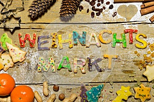 Christmas decoration and cookie letters on wooden table, german