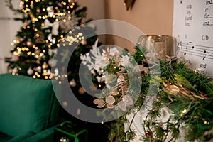 Christmas decoration detail with christmas tree, oranments and warm lights