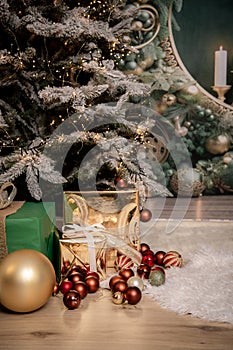 Christmas decoration detail with red and yellow ornaments, presents, christmas tree and warm lights