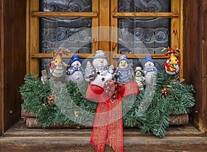 Christmas decoration dolls at the window made of wood