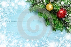 Christmas decoration with fir branches, snowflake on blue board wooden background with copy space