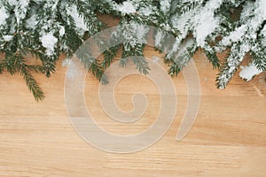 Christmas Decoration Of Fir Branches With Snowflakes On Wooden Background
