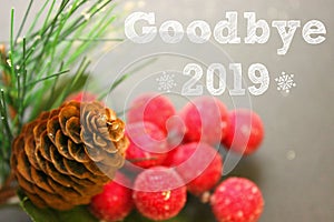 Christmas decoration, fir cone and branch, text goodbye 2019