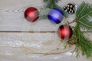 Christmas decoration, fir and spruce twigs, pine cones and baubles, on a rustic wooden background, space for text, Christmas
