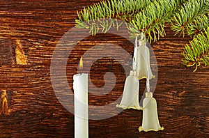 Christmas decoration. Fir-tree, bells and candle