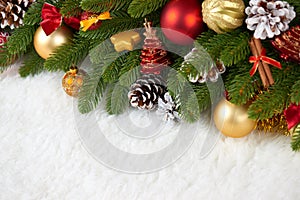 Christmas decoration on fir tree branch closeup, gifts, xmas ball, cone and other object on white blank space fur, holiday concept