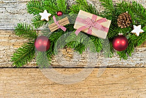 Christmas decoration with fir tree branch, gift box on wood background