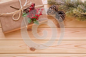 Christmas decoration - fir tree branch, gift and holly berry