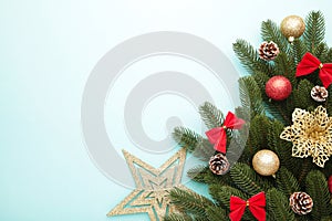 Christmas decoration. Fir-tree branch with gold star, christmas flower and balls on mint