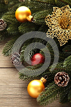 Christmas decoration. Fir-tree branch with red and gold balls on grey background