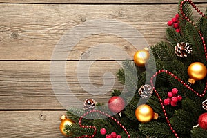 Christmas decoration. Fir-tree branch with red and gold balls on grey background