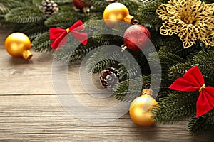 Christmas decoration. Fir-tree branch with red and gold balls on grey background