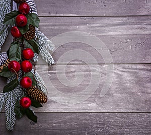 Christmas decoration of fir tree and conifer cone on textured wood background