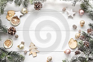 Christmas decoration of fir tree and conifer cone on wood background, top view. Copy space