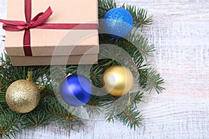 Christmas decoration fir tree with gift box and many balls, on wooden board