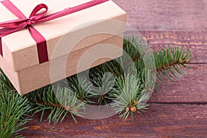 Christmas decoration fir tree with gift box on wooden board