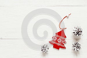 Christmas decoration fir- tree and pine cones on white boards. S