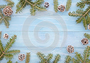 Christmas decoration Fir tree with snow Pine cones on blue planks wooden background Flat lay frame mockup. Minimal