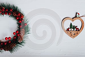 Christmas decoration fir tree and wooden heart against a white background