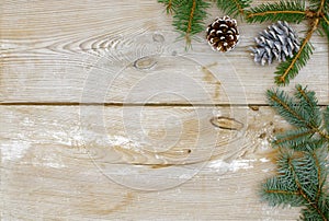 Christmas decoration, fir twigs, spruce and pine cones on a rustic wooden background, space for text, background, wallpaper