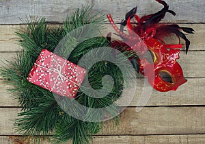 Christmas decoration: fir wreath, gift box and carnival mask