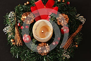 Christmas decoration in the form of a candle and a wreath