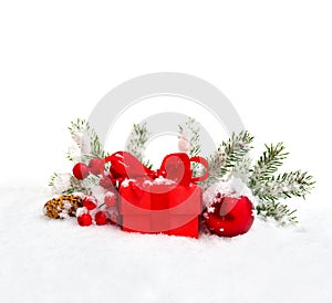 Christmas decoration. Gift box, branch christmas tree, christmas balls, berry and cones spruce on snow on white background