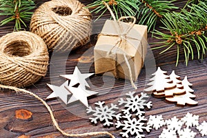 Christmas decoration, gift box in craft paper with twine rope, concept background, top view on wood table surface