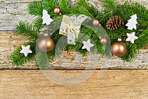 Christmas decoration with gift box, ornaments and fir branch on rustic wood background