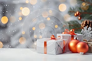 Christmas decoration. Gift boxes and Christmas balls on table and ornaments over abstract bokeh background with copy space.