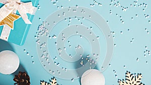 Christmas decoration. Gift boxes and Christmas decorations on pastel blue background, flat lay. Top view. Copy space