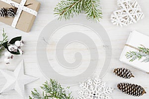 Christmas decoration, gift, frosted cypress branches, pine cones. Wooden background