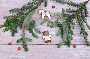 Christmas decoration with gingerbread cookies,fir branches and red berries on old wooden board