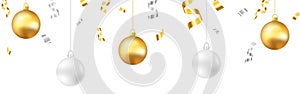 Christmas decoration. Gold and silver balls on white backdrop. Falling confetti and tinsel. Winter greeting card or